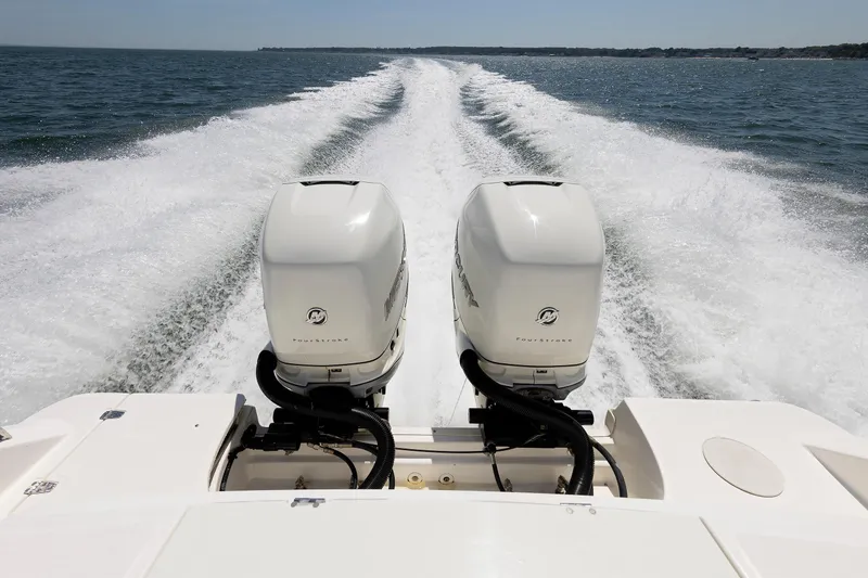 Slide: The Image of Boston Whaler 330 Outrage 2016 with dual outboard engines cruising on open water. - 36