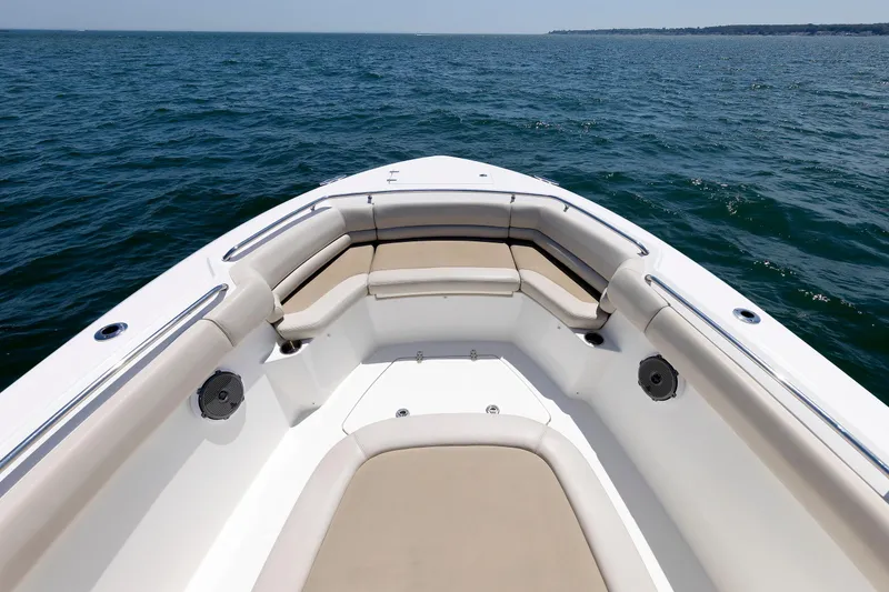 Slide: The Image of Boston Whaler 330 Outrage 2016 boat bow with cushioned seating on open water. - 5
