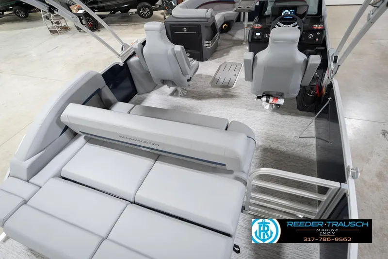 Slide: The Image of 2026 Bennington 22 MSB pontoon boat interior with plush seating and modern dashboard. - 12