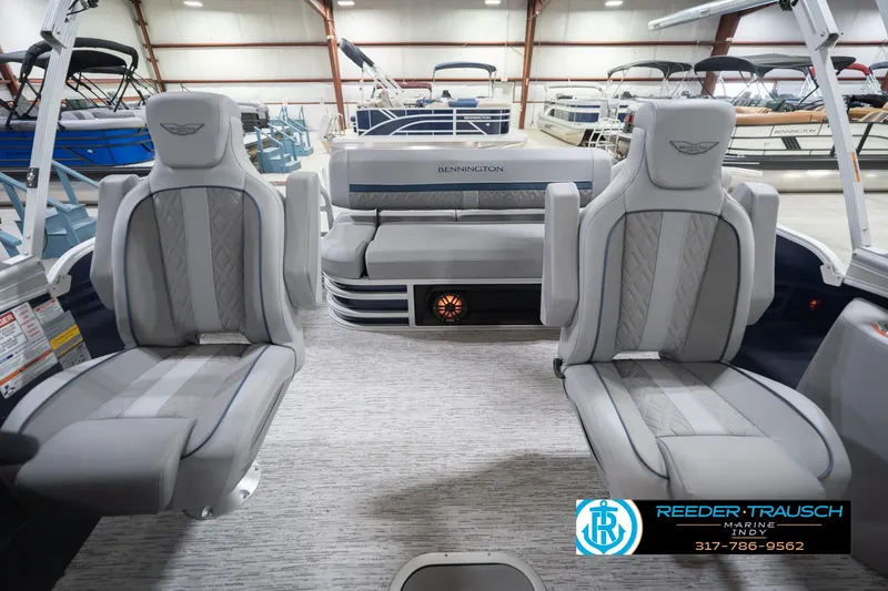 Slide: The Image of 2026 Bennington 22 MSB pontoon boat interior with luxurious seating in a showroom. - 15