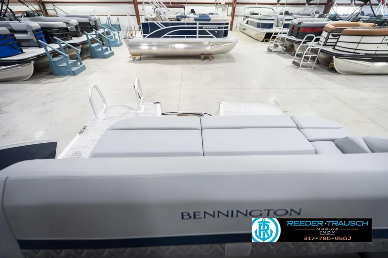 Slide: The Image of 2026 Bennington 22 MSB pontoon boat in showroom with other boats. - 16