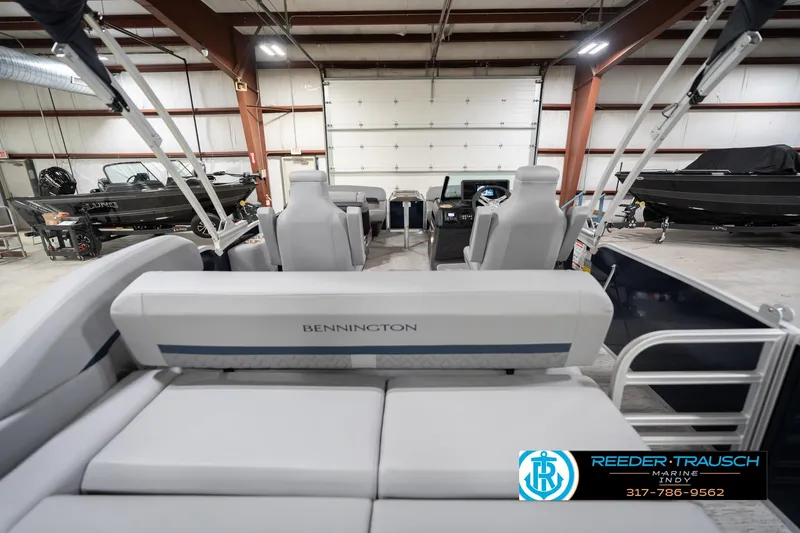 Slide: The Image of 2026 Bennington 22 MSB pontoon boat interior in a showroom with other boats. - 17