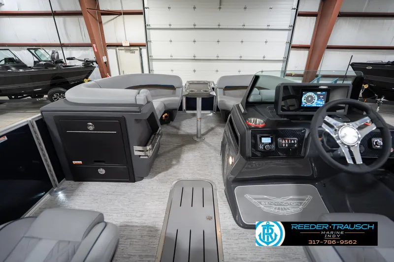 Slide: The Image of 2026 Bennington 22 MSB boat interior with modern dashboard and seating in showroom. - 18