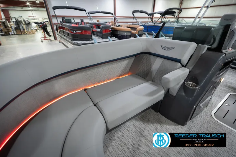 Slide: The Image of 2026 Bennington 22 MSB pontoon boat interior with luxurious seating and ambient lighting. - 22