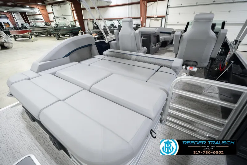 Slide: The Image of 2026 Bennington 22 MSB pontoon boat interior with gray seating in showroom. - 30