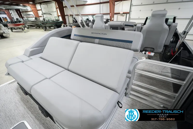 Slide: The Image of 2026 Bennington 22 MSB pontoon boat interior with plush seating in showroom. - 32