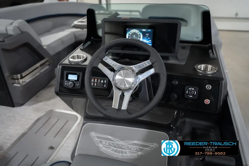 Slide: The Image of 2026 Bennington 22 MSB boat dashboard with steering wheel and digital display. - 34