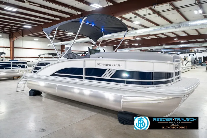 Slide: The Image of 2026 Bennington 22 MSB pontoon boat in showroom with canopy and sleek design. - 4