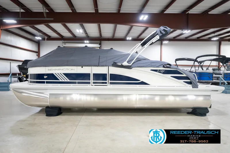 Slide: The Image of 2026 Bennington 22 MSB pontoon boat in showroom, covered and ready for sale. - 53