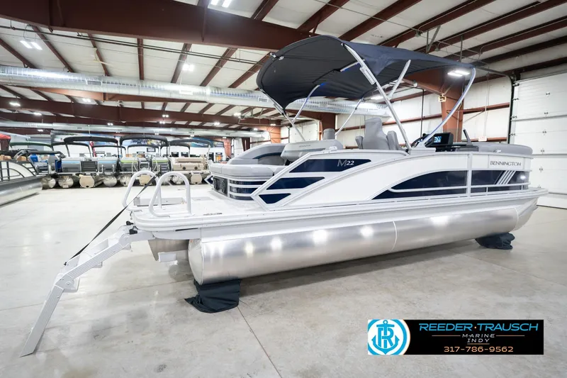 Slide: The Image of 2026 Bennington 22 MSB pontoon boat displayed indoors at Reeder Trausch Marine. - 6