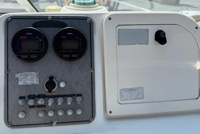 Slide: The Image of Control panel of a 2004 Glastron 213 WA boat with gauges and switches. - 5