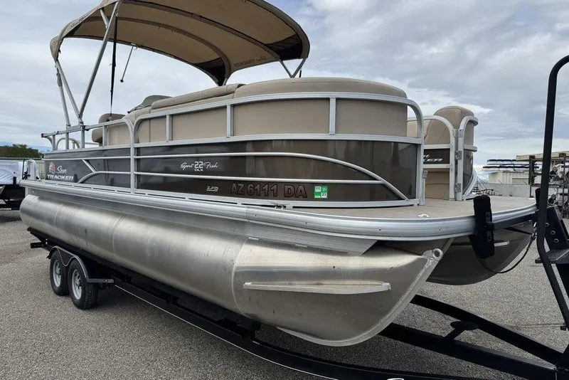 Slide: The Image of 2018 Sun Tracker SportFish 22 XP3 pontoon boat on trailer, side view. - 11