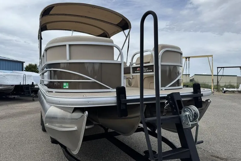 Slide: The Image of 2018 Sun Tracker SportFish 22 XP3 pontoon boat on trailer, parked outdoors. - 12