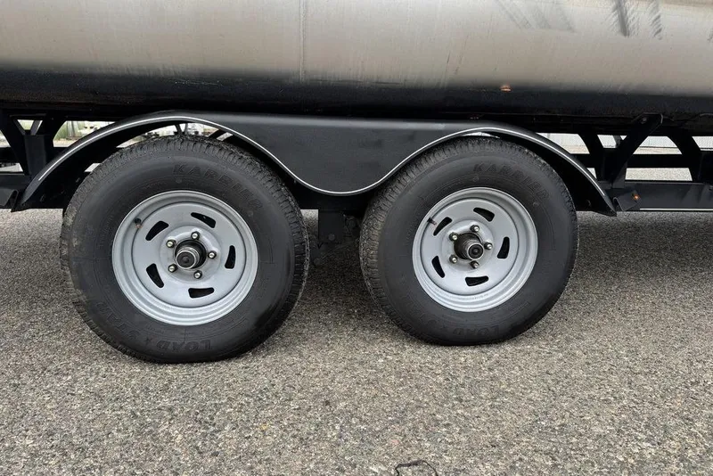 Slide: The Image of Trailer wheels of a 2018 Sun Tracker SportFish 22 XP3 on asphalt. - 13