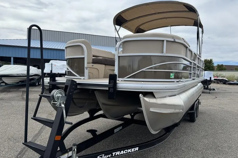 Slide: The Image of 2018 Sun Tracker SportFish 22 XP3 pontoon boat on trailer, parked outdoors. - 18