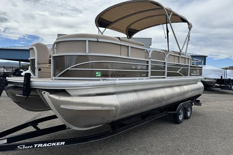 Slide: The Image of 2018 Sun Tracker SportFish 22 XP3 pontoon boat on trailer, parked outdoors. - 24