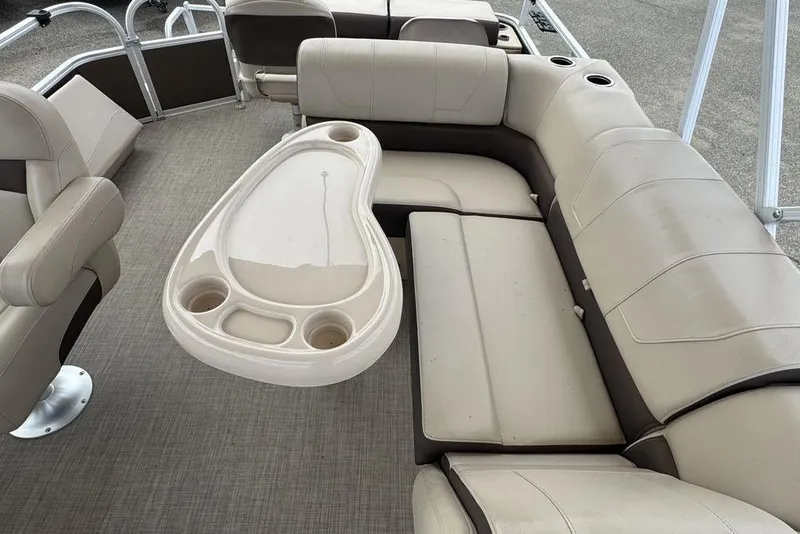Slide: The Image of 2018 Sun Tracker SportFish 22 XP3 interior with beige seating and table. - 30