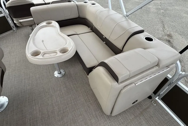 Slide: The Image of 2018 Sun Tracker SportFish 22 XP3 interior with beige seating and a table. - 32