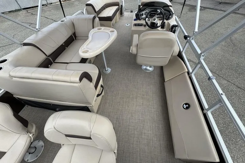 Slide: The Image of 2018 Sun Tracker SportFish 22 XP3 pontoon boat interior with beige seating and steering console. - 39