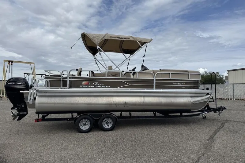 Slide: The Image of 2018 Sun Tracker SportFish 22 XP3 pontoon boat with canopy and Mercury outboard motor. - 4