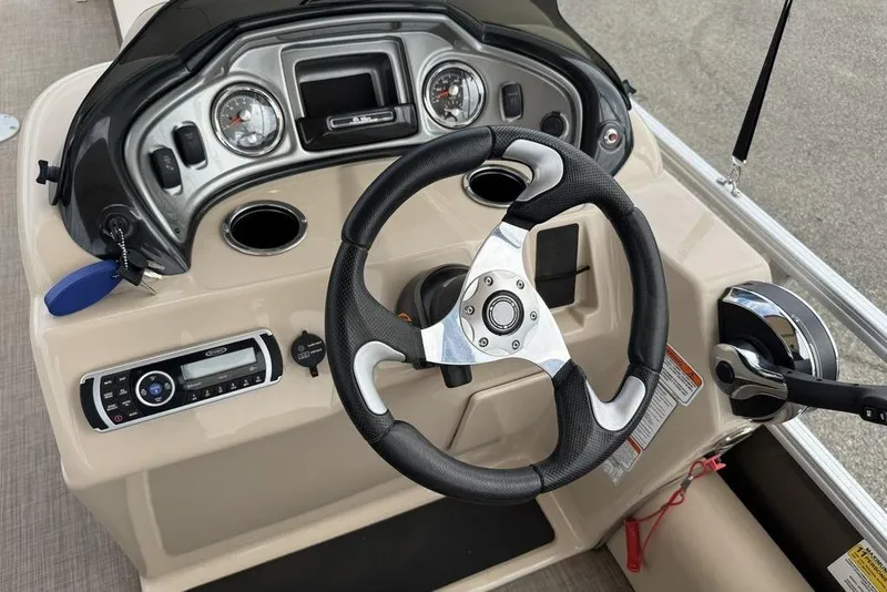 Slide: The Image of 2018 Sun Tracker SportFish 22 XP3 boat dashboard with steering wheel and controls. - 41