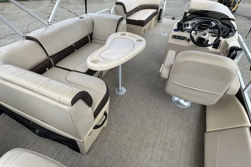 Slide: The Image of 2018 Sun Tracker SportFish 22 XP3 pontoon boat interior with beige seating and steering console. - 42