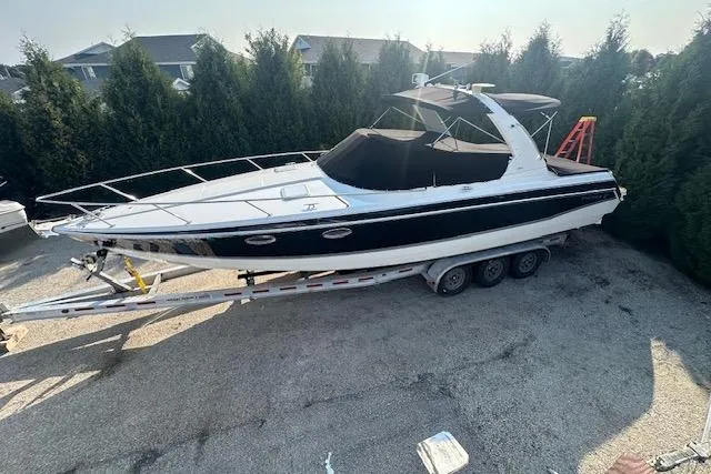 The Image of 2008 Formula 330 Sun Sport boat on trailer, parked outdoors. - 0