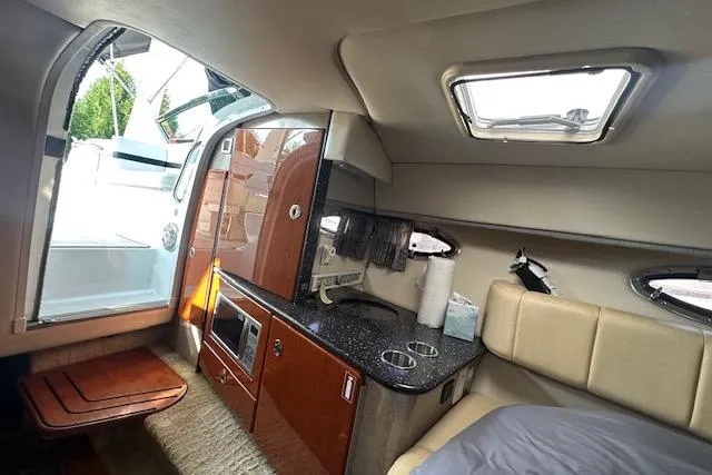 Slide: The Image of 2008 Formula 330 Sun Sport cabin interior with beige seating and decorative pillows. - 20