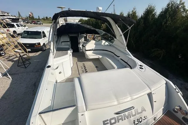 Slide: The Image of 2008 Formula 330 Sun Sport boat dashboard with steering wheel and navigation controls. - 3