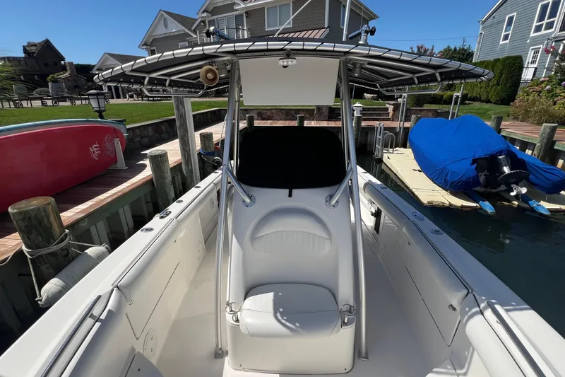 Slide: The Image of 2004 Robalo R260 Center Console boat docked near waterfront homes. - 11