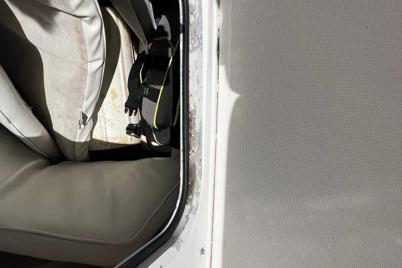 Slide: The Image of 2004 Robalo R260 Center Console interior with seat and storage area. - 12