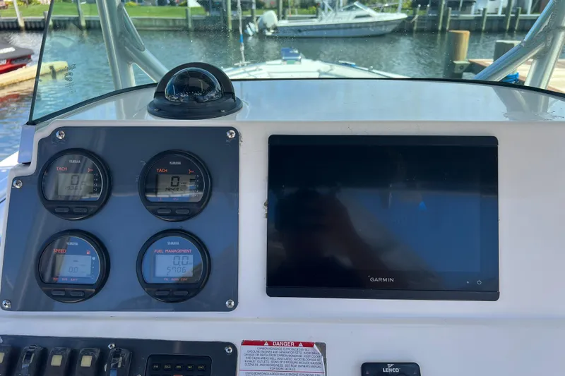 Slide: The Image of 2004 Robalo R260 Center Console dashboard with Yamaha gauges and Garmin display. - 25