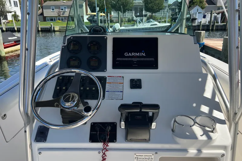 Slide: The Image of 2004 Robalo R260 Center Console boat dashboard with Garmin navigation system. - 26