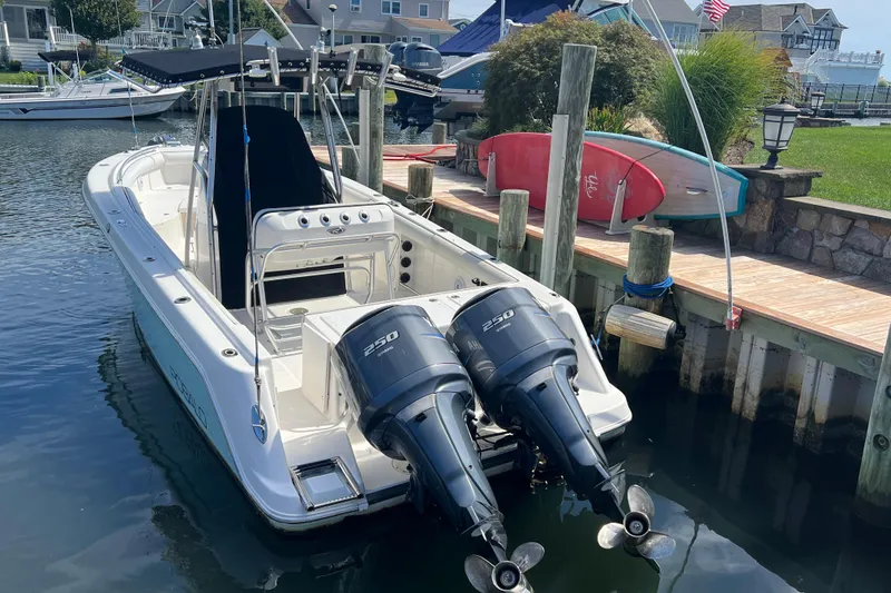 Slide: The Image of 2004 Robalo R260 Center Console boat docked with twin 250 engines. - 4