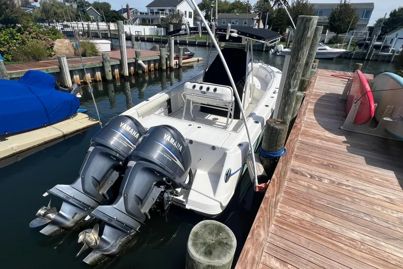Slide: The Image of 2004 Robalo R260 Center Console boat docked with twin Yamaha engines. - 5