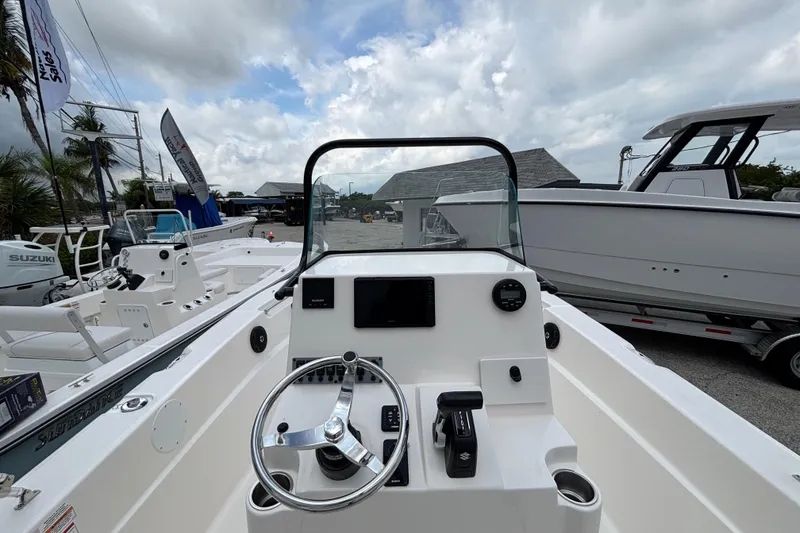 Slide: The Image of 2026 Sea Born LX21 Center Console boat interior with steering wheel and controls. - 14