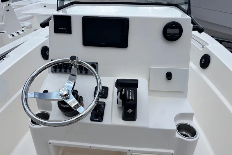 Slide: The Image of 2026 Sea Born LX21 Center Console boat dashboard with steering wheel and controls. - 16