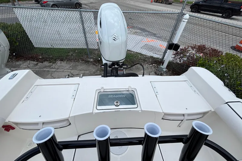 Slide: The Image of 2026 Sea Born LX21 Center Console boat with outboard motor and rod holders. - 17