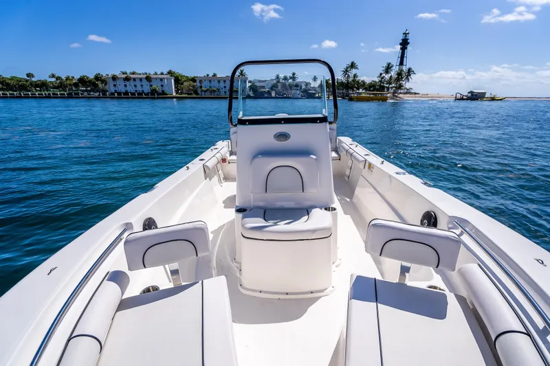 Slide: The Image of 2026 Sea Born LX21 Center Console boat on calm water near a lighthouse. - 23