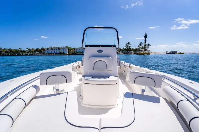 Slide: The Image of 2026 Sea Born LX21 Center Console boat on clear blue water near a lighthouse. - 24
