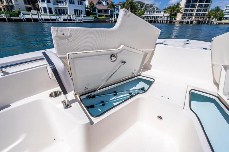Slide: The Image of 2026 Sea Born LX21 Center Console boat with open storage compartments on a sunny day. - 25
