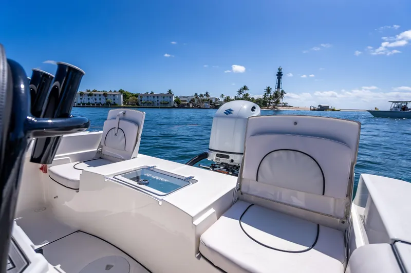 Slide: The Image of 2026 Sea Born LX21 Center Console boat on water near lighthouse and palm trees. - 29