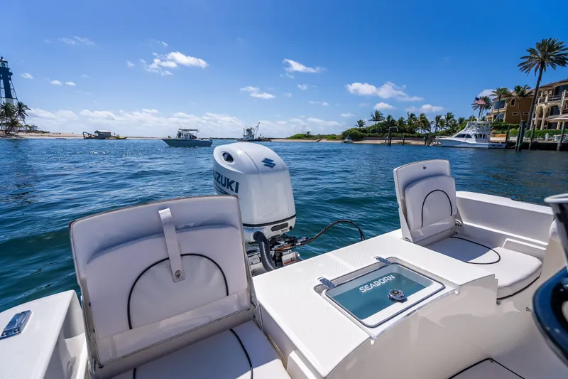Slide: The Image of 2026 Sea Born LX21 Center Console boat on scenic waterfront with Suzuki engine. - 31