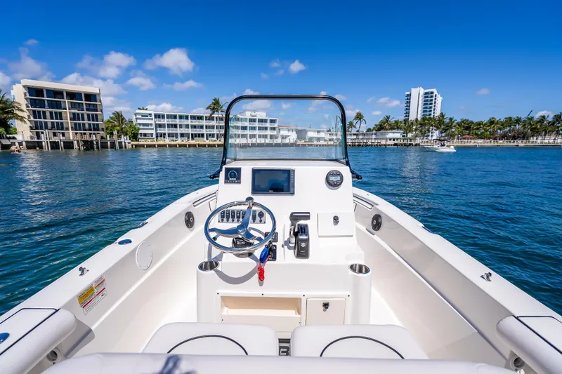 Slide: The Image of 2026 Sea Born LX21 Center Console boat on clear blue water, with modern buildings in background. - 34