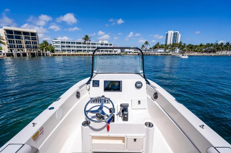 Slide: The Image of 2026 Sea Born LX21 Center Console boat on clear blue water, with modern buildings in background. - 35