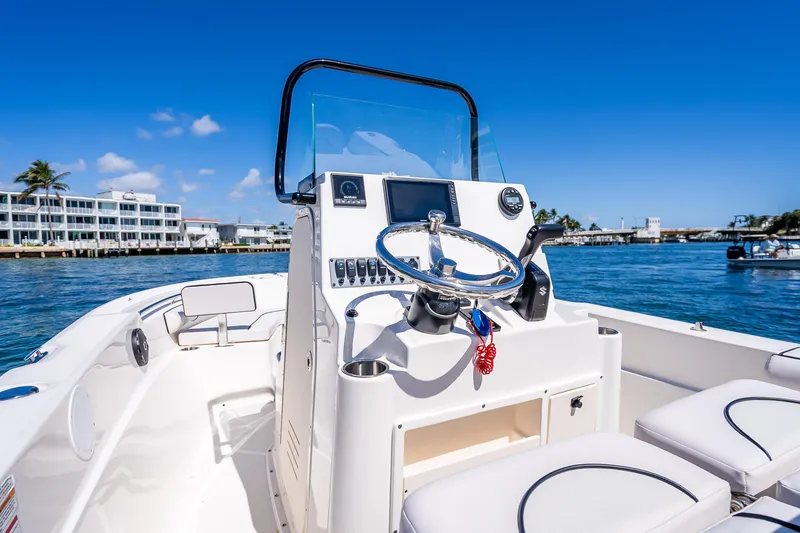 Slide: The Image of 2026 Sea Born LX21 Center Console boat on water, clear sky, modern design. - 36