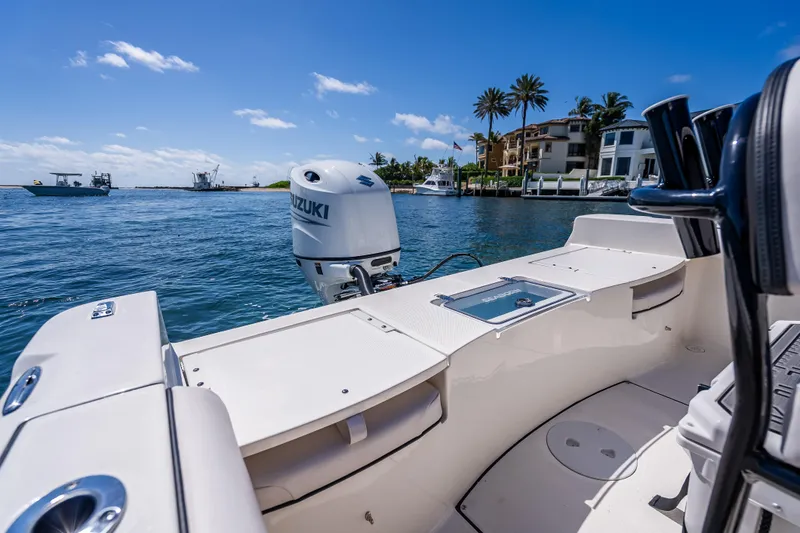 Slide: The Image of 2026 Sea Born LX21 Center Console boat on water, featuring Suzuki outboard motor. - 38