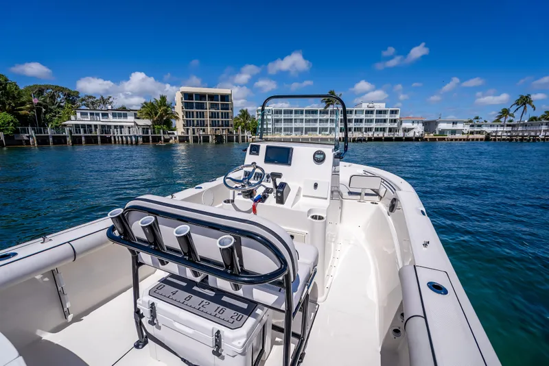 Slide: The Image of 2026 Sea Born LX21 Center Console boat on calm water, with coastal buildings in background. - 39