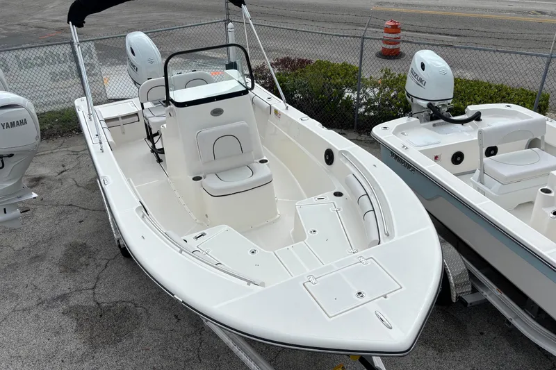 Slide: The Image of 2026 Sea Born LX21 Center Console boat with Yamaha and Suzuki engines, parked on a trailer. - 4