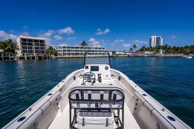 Slide: The Image of 2026 Sea Born LX21 Center Console boat on a sunny waterfront with modern buildings. - 41